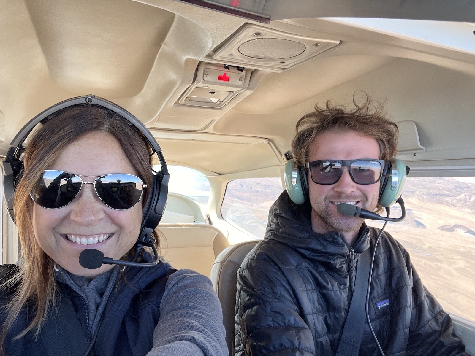 Two people in the cockpit of an airplane during flight instruction